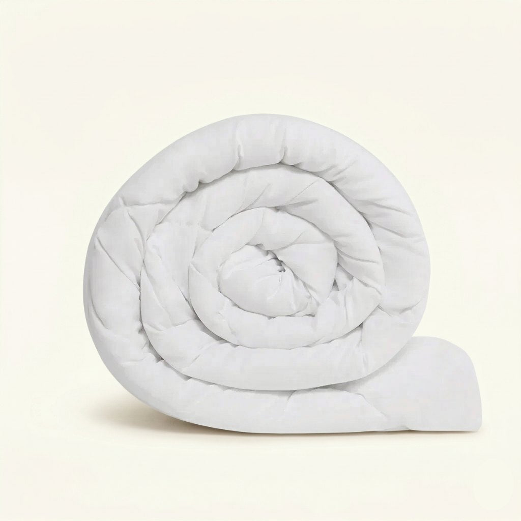 Rolled-up white comforter on a beige background