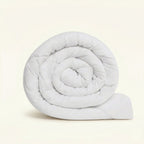 Rolled-up white comforter on a beige background