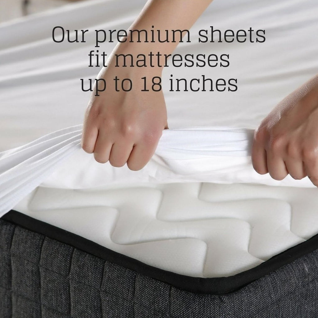 Person adjusting white mattress sheets on a gray mattress with text about sheet size compatibility.