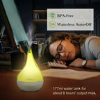 Woman sleeping at a desk with a yellow and white humidifier, BPA-Free and Waterless Auto-Off features highlighted.