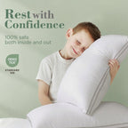 Child hugging a large pillow with 'Rest with Confidence' text and Oeko-Tex logo on a light green background
