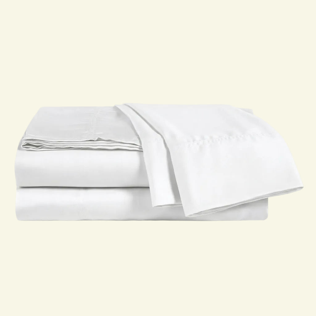 Set of white bed sheets on a light beige background