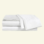 Set of white bed sheets on a light beige background