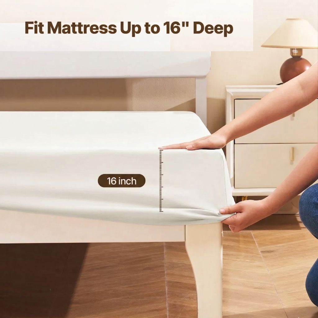 Person measuring a sheet set with a ruler on a bed, indicating it fits up to 16 inches deep.