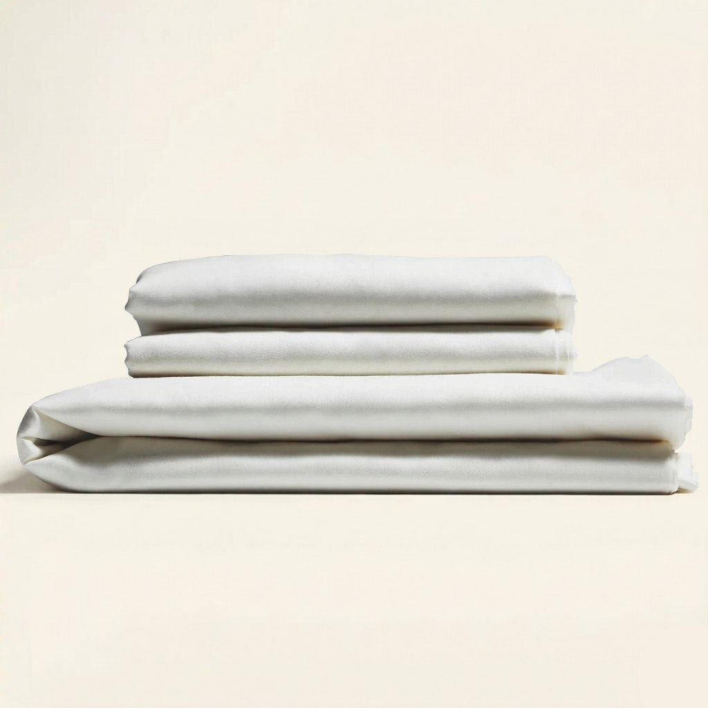 Stack of white folded bed sheets on a beige background