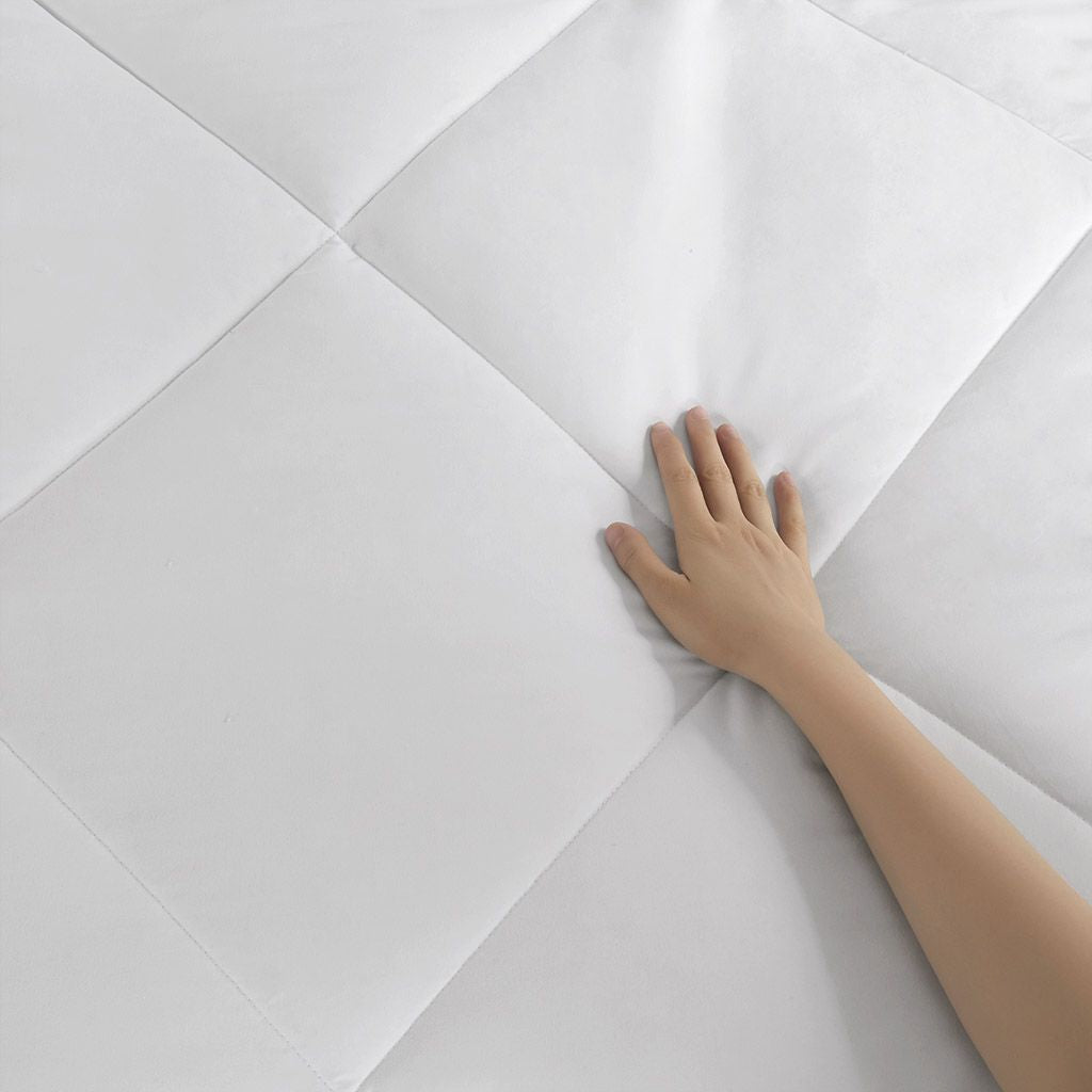 Hand touching a white geometric-patterned surface