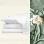 Stack of white sheets on a light beige background with green fabric and a white flower on a green background.